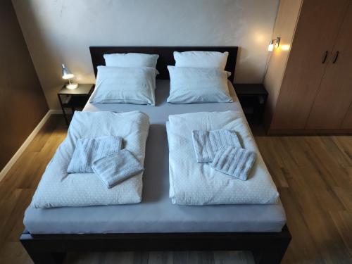 two beds in a room with towels on them at Left Coast studio apartment in Belgrade