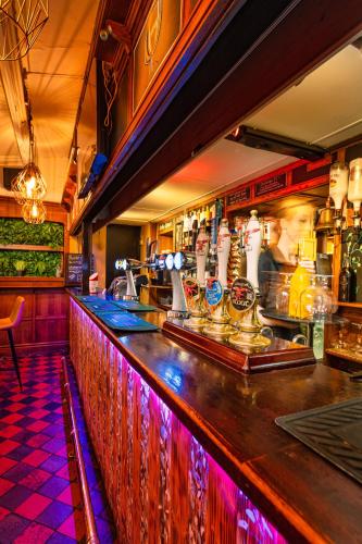 a bar with purple lights on the counter at Boars Head Hotel in Carmarthen