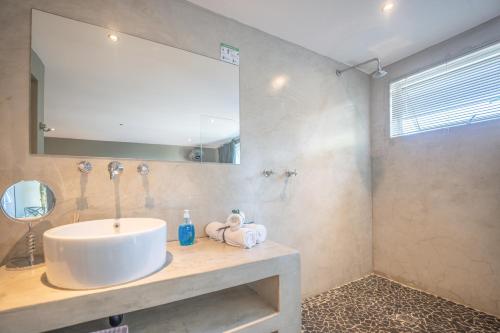 a bathroom with a sink and a mirror at A Stone's Throw Accommodation in Grahamstown
