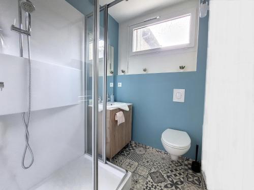 a bathroom with a toilet and a shower at LE CARILLOUN in Mirande