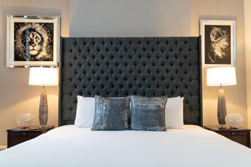 a bedroom with a large bed and two lamps at Boars Head Hotel in Carmarthen