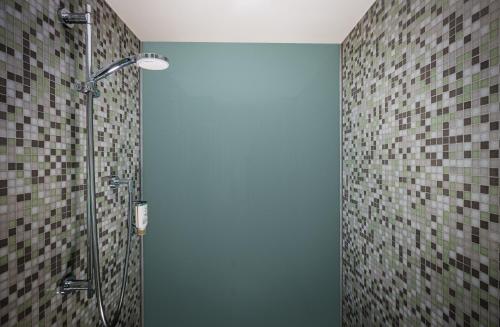 a shower with a glass door in a bathroom at Lindner Hotel Berlin Ku'damm, part of JdV by Hyatt in Berlin