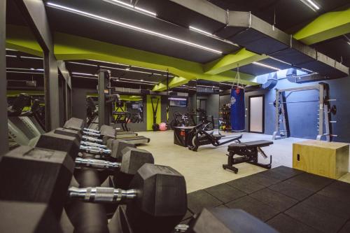 a gym with several treadmills and exercise equipment at Star Hill Hotel in Pristina