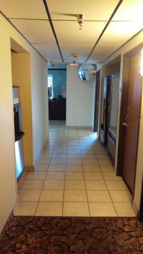 a hallway in a office building with a tile floor at Super 8 by Wyndham Thurmont in Thurmont
