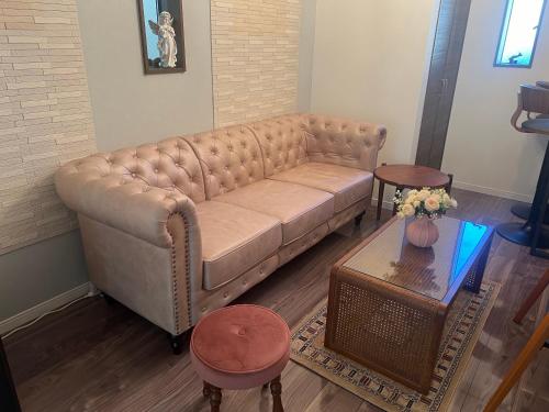 a living room with a couch and a table at QiQi Serenity Tokyo Exclusive New 3-Story Home, 14min to Skytree, Asakusa Area in Tokyo