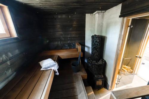 an inside view of a small room with a stove at Romantic cottage with sauna in Porvoo