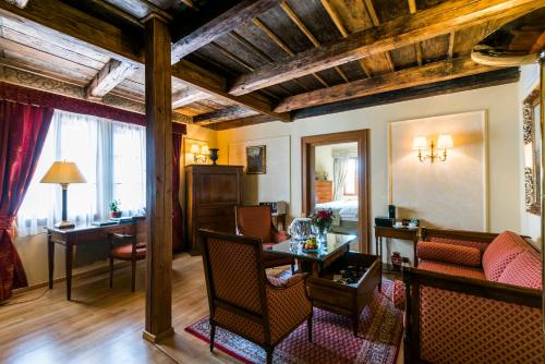 a living room with a couch and a table at Golden Well in Prague