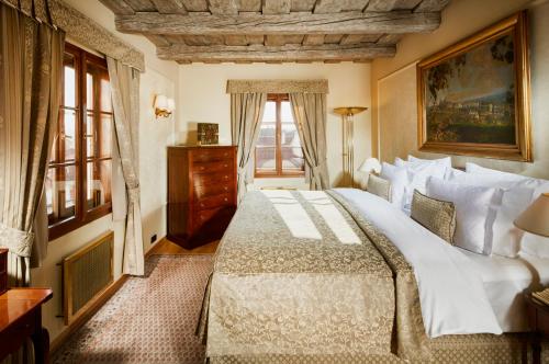 a bedroom with a large bed and a window at Golden Well in Prague