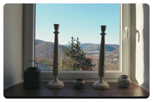 a window with three vases sitting on a window sill at la Ferme de Vazerat in Massiac