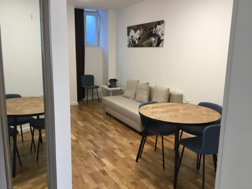 ein Wohnzimmer mit 2 Tischen und einem Sofa in der Unterkunft Sieveringer A-B in Wien