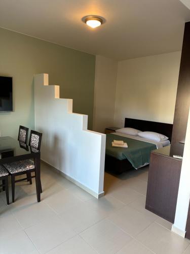 a room with a bed and a staircase in it at DRYADES in Agios Nikolaos
