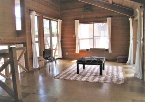un soggiorno con panca in una camera con finestre di Gozenyama Youth Travel Village - Vacation STAY 46761v 