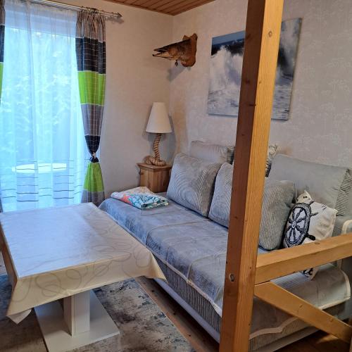 a living room with a bunk bed and a couch at Fewo Seepferdchen in Zempin