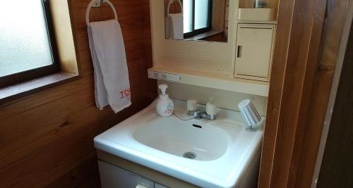 a bathroom with a white sink and a mirror at Toukaen campsite - Vacation STAY 23960v in Uenohara