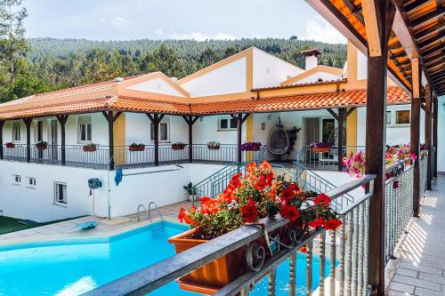 a villa with a swimming pool and a house at Estalagem Bela Vista in Mondim de Basto