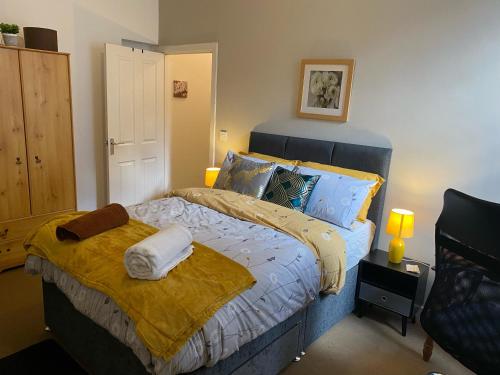 a bedroom with a bed with towels on it at Branxiar Suite - 1bedroom Executive Suite & Apartment in Wallsend in Old Walker