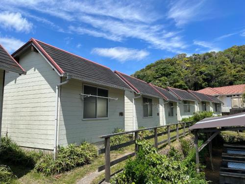 a row of houses with mountains in the background at Yotsubaso Bungalow Village - Vacation STAY 85282v in Moriya