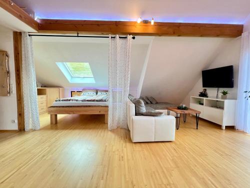 a bedroom with a bed and a living room at Ferienapartment Huber in Oberkirch