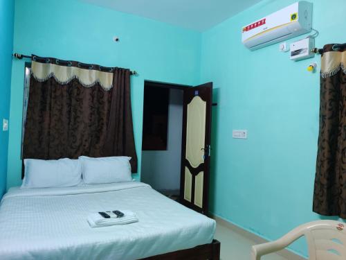 a bedroom with a bed with a blue light at ‌‌Florence guest house in Puducherry