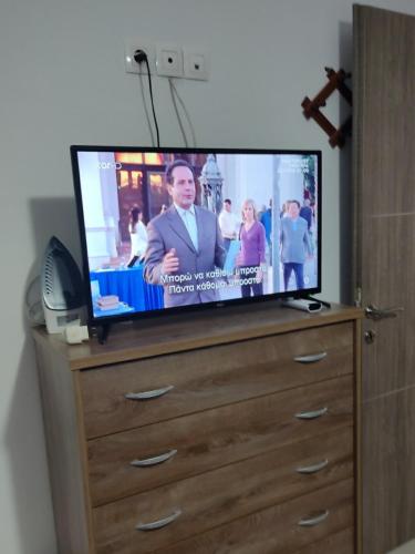 a flat screen tv sitting on top of a dresser at Stavroula's Houses in Kélla