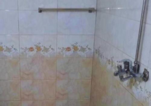 a shower with a faucet in a bathroom at Hotel Day In Emporium in Lahore
