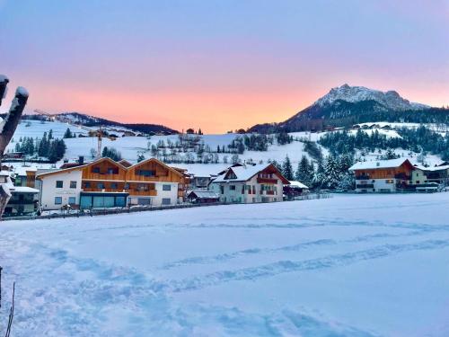 a town covered in snow with a mountain in the background at App Piz de Plaies -ciasa Lavarella in San Vigilio Di Marebbe