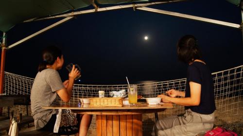 a group of three people sitting at a table at Grand Beach - Vacation STAY 23981v in Iki