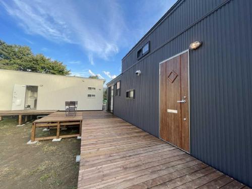 a wooden deck next to a building with a door at Camp Field Kijimadaira - Vacation STAY 85297v in Nakamachi