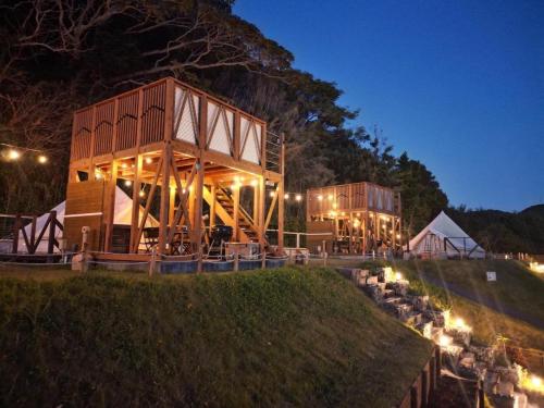 a large building on a hill at night at FARMER'S FIELDZ - Vacation STAY 42161v in Hongō