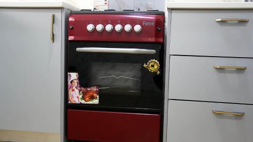 a red oven in the middle of a kitchen at Tropical Oasis in Accra - 2 Bedroom Apartment in Accra