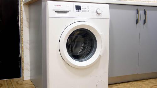 a white washer and dryer in a kitchen at Tropical Oasis in Accra - 2 Bedroom Apartment in Accra