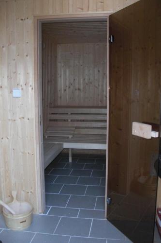 a sauna with a bench and a toilet in a room at Pension Lažany in Lažany