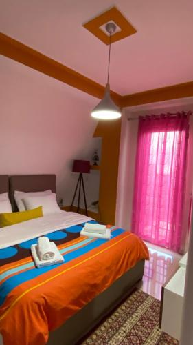 a bedroom with a bed and a ceiling at Your Apartment in Pogradec