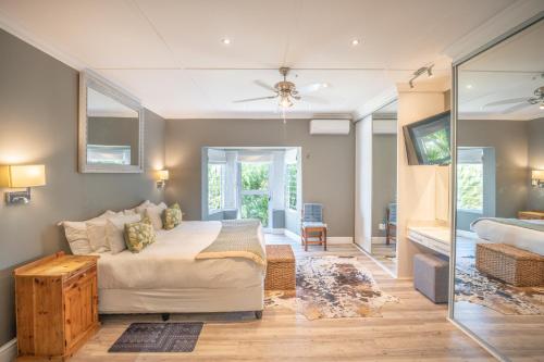 a bedroom with a bed and a sliding glass door at A Stone's Throw Accommodation in Grahamstown