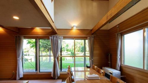 a dining room with a table and a large window at Kabato County - Camp - Vacation STAY 42183v in Shintotsukawa