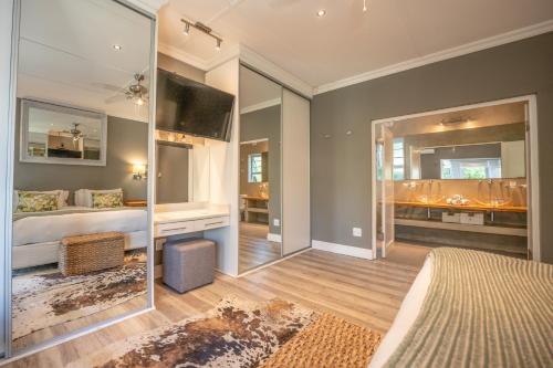 a bedroom with a bed and a large mirror at A Stone's Throw Accommodation in Grahamstown