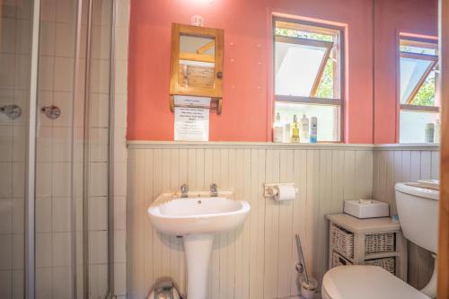 a bathroom with a sink and a toilet at A Stone's Throw Accommodation in Grahamstown