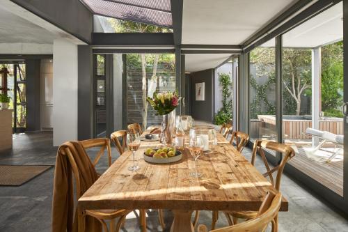 a dining room with a wooden table and chairs at Spanish Farm Boutique Hotel & Villas in Somerset West