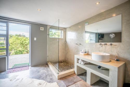 a bathroom with a sink and a shower at A Stone's Throw Accommodation in Grahamstown