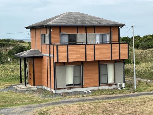 a large wooden house on the side of a field at Hasaki Seaside Campsite - Vacation STAY 51112v in Shari