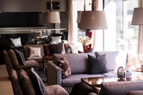a living room with a couch and chairs at Sundvolden Hotel in Sundvollen