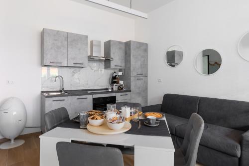 a kitchen and living room with a table with food on it at La dimora degli asinelli in Bologna