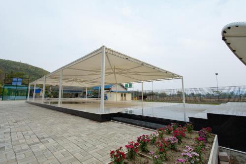 a large white pavilion with flowers in a courtyard at RaDiant Club & Resort in Imphal