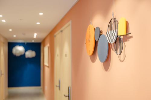 a hallway with several utensils hanging on the wall at Hithere City Myeongdong in Seoul