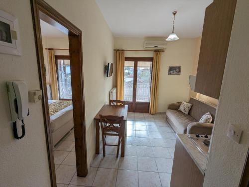 a living room with a couch and a table at Pagaseon Rooms and Apartments in Kala Nera