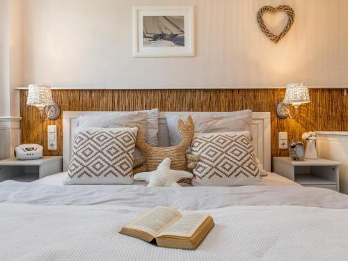 a bedroom with a bed with two books on it at Ostseeklang in Zingst