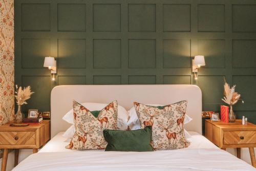 a bedroom with green walls and a bed with pillows at Luxury, Castle View Apartment! Spa Treatments , Windsor Town Centre in Windsor