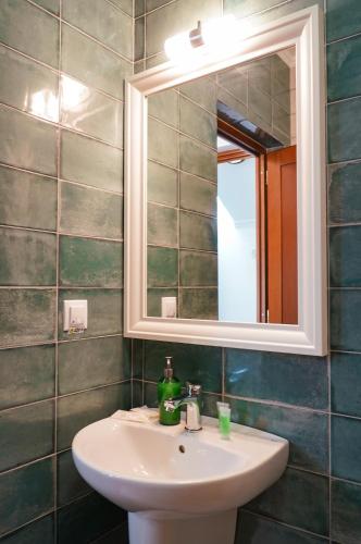 a bathroom with a sink and a mirror at Paleus Resort in Oradea