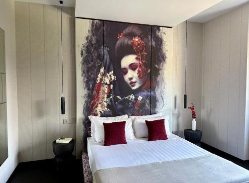 a bedroom with a large painting of a woman at Hotel Mealba in Saronno