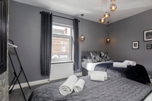 a bedroom with two beds and a window at The Milton sleeps 8 close to York city centre pet friendly in York